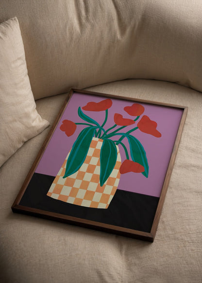 Vibrant checkerboard vase with flowers against a purple background.