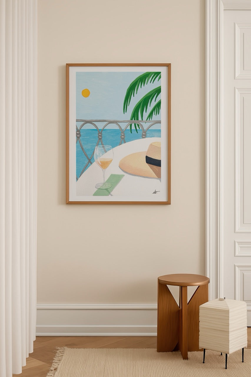 Serene coastal scene with a drink and hat, Cote d’Azur style.
