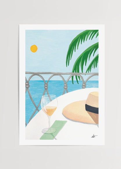 Serene coastal scene with a drink and hat, Cote d’Azur style.