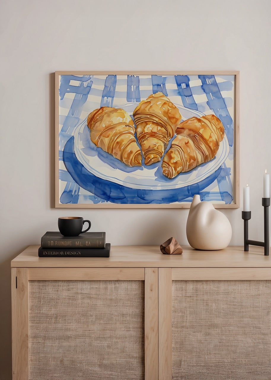 Illustration of croissants on a blue tablecloth, perfect for kitchen decor.