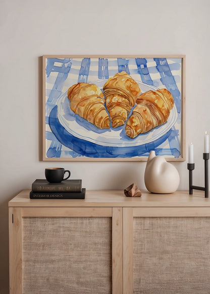 Illustration of croissants on a blue tablecloth, perfect for kitchen decor.