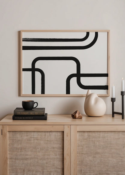Monochrome abstract art print featuring flowing black lines on a white background.