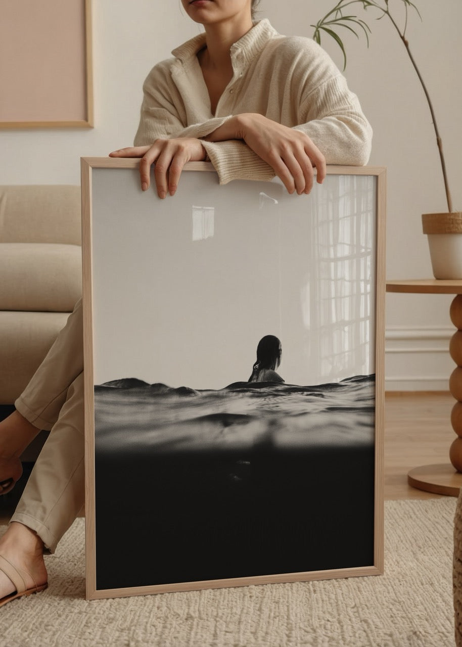 A black and white photograph of a woman in tranquil waters, representing serenity.