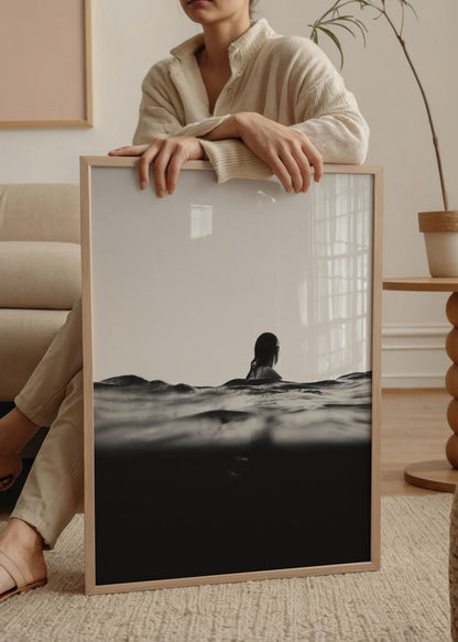 A black and white photograph of a woman in tranquil waters, representing serenity.