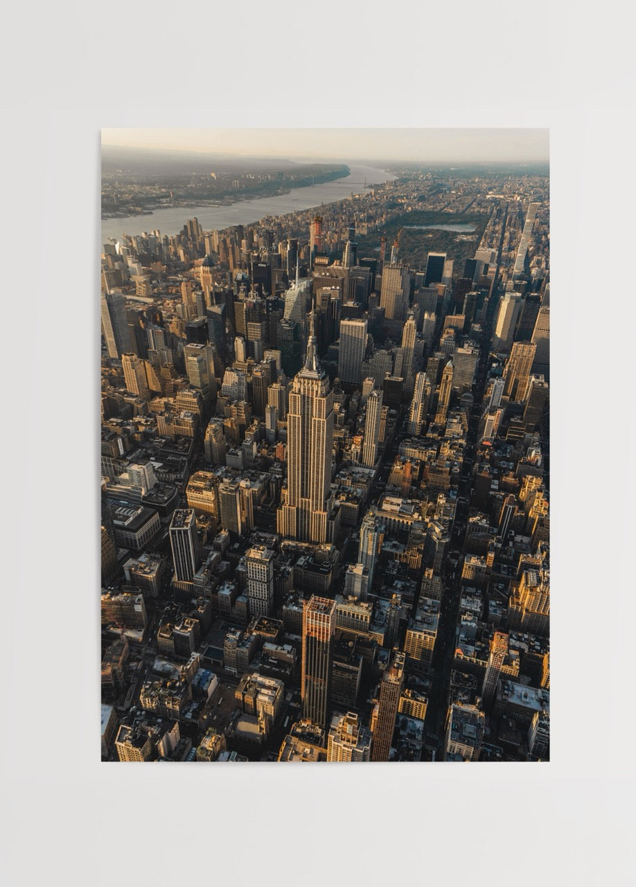 Aerial view of New York City at sunset featuring the Empire State Building.