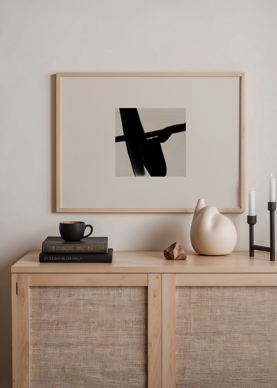 Monochrome abstract brushstroke artwork on a neutral background.