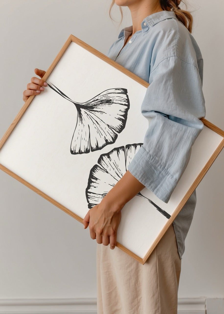 Elegant black and white illustration of ginkgo leaves on a white background.