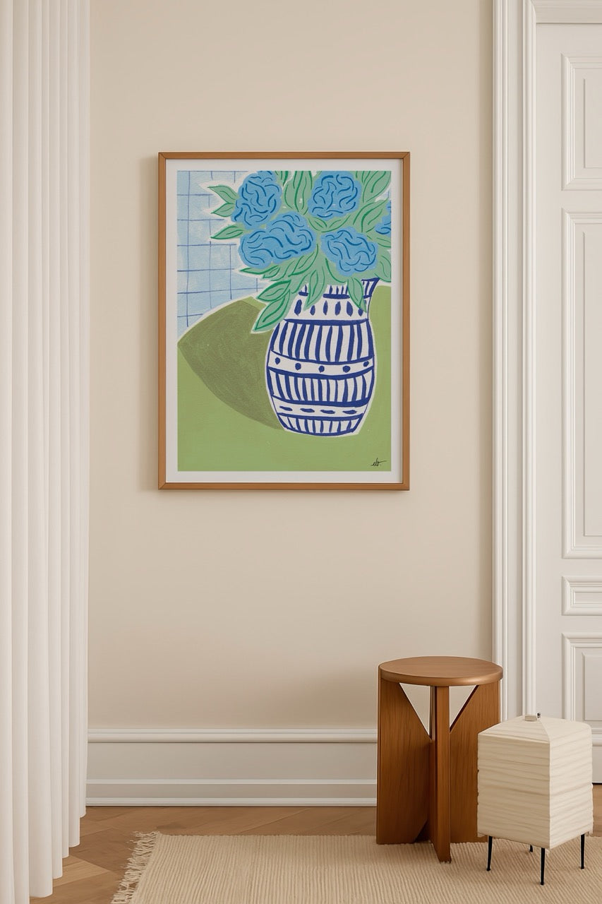 Blue hydrangeas in a patterned vase against a green background.