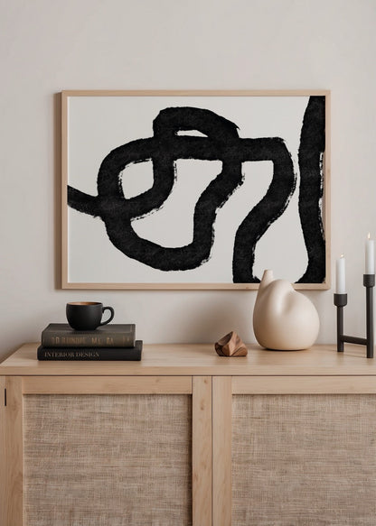 Abstract art print featuring fluid black lines on a white background.