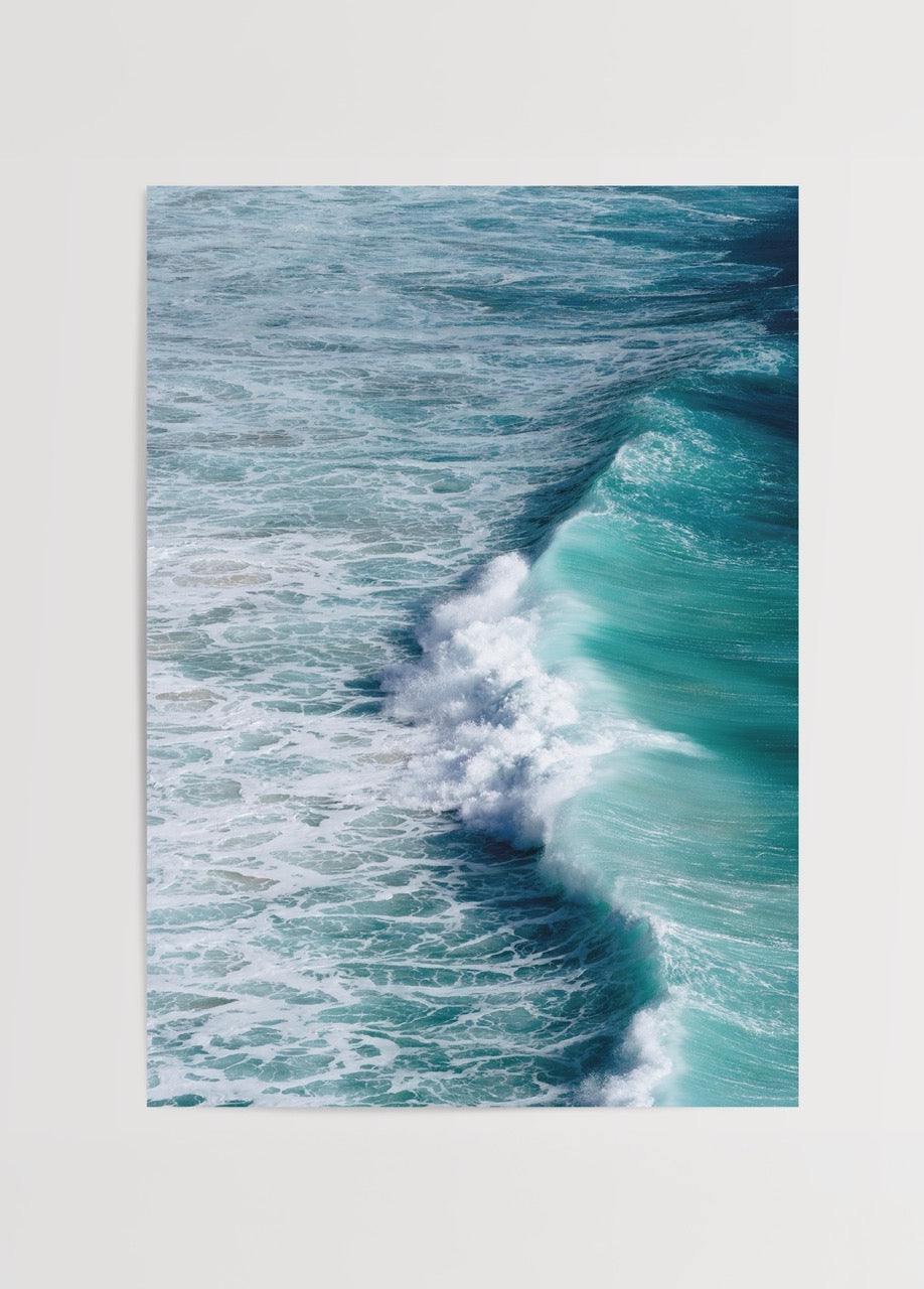 A captivating wall art piece showing ocean waves meeting the shore in vibrant blue tones.