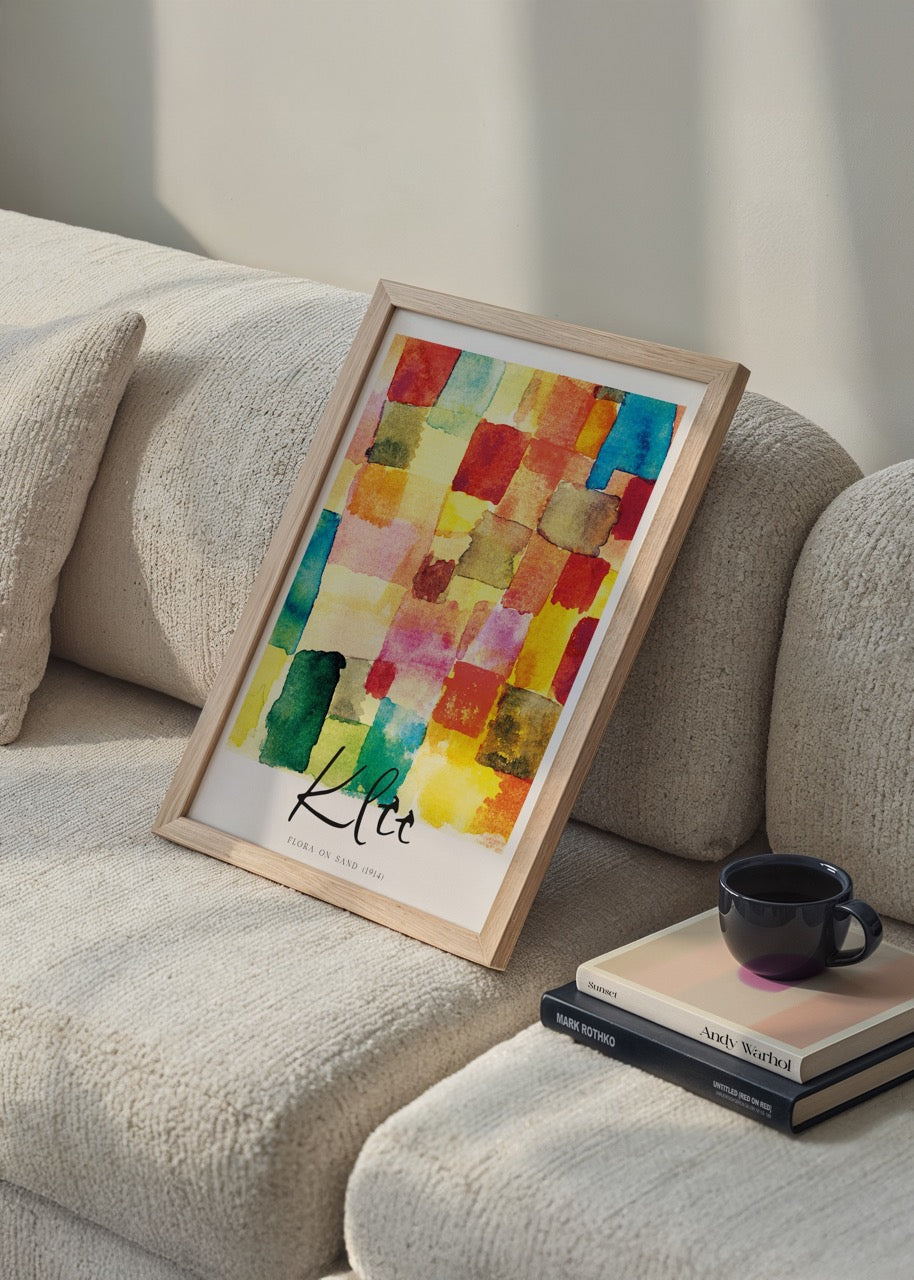 Vibrant floral mosaic artwork featuring a blend of colours on sand.