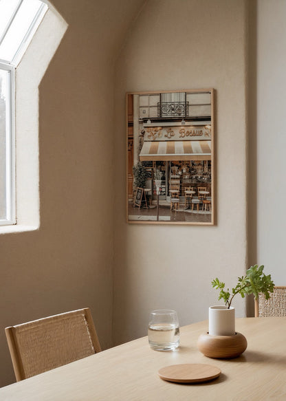 Charming wall art of a café facade, evoking Parisian elegance.