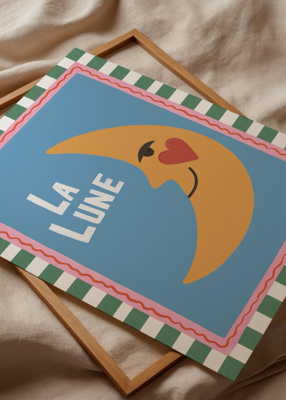 Whimsical poster print featuring a smiling crescent moon on a blue background.