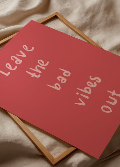 Leave the Bad Vibes Out poster in vibrant red with playful typography.