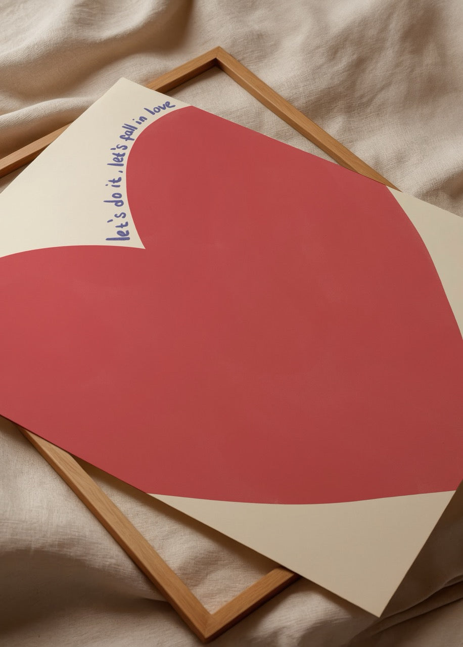 A vibrant red heart on a soft beige background with the text &