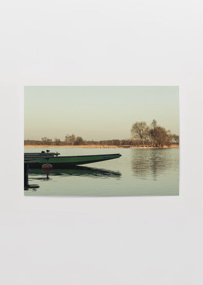 Lone boat on a tranquil lake in Białystok, showcasing serene nature.