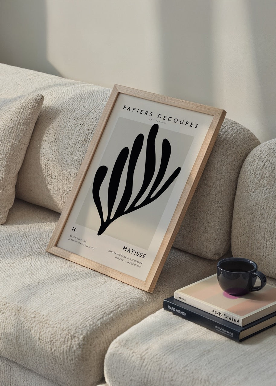 A bold cut-out design artwork featuring organic shapes in black.