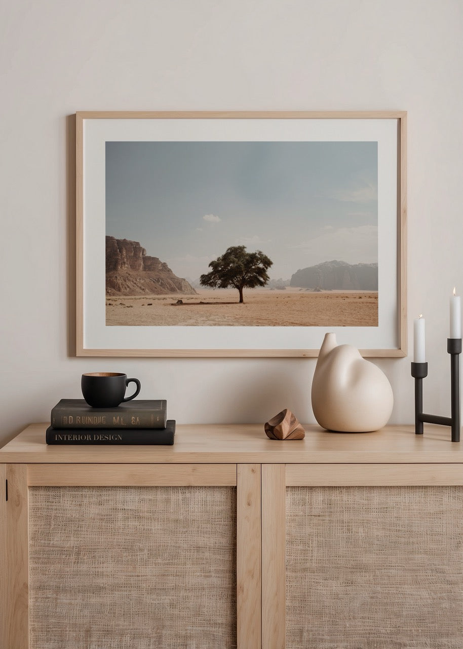 A serene desert landscape featuring a solitary tree under a clear blue sky.