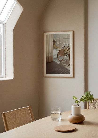 Poster of a bicycle illuminated by sunlight in a stylish interior.