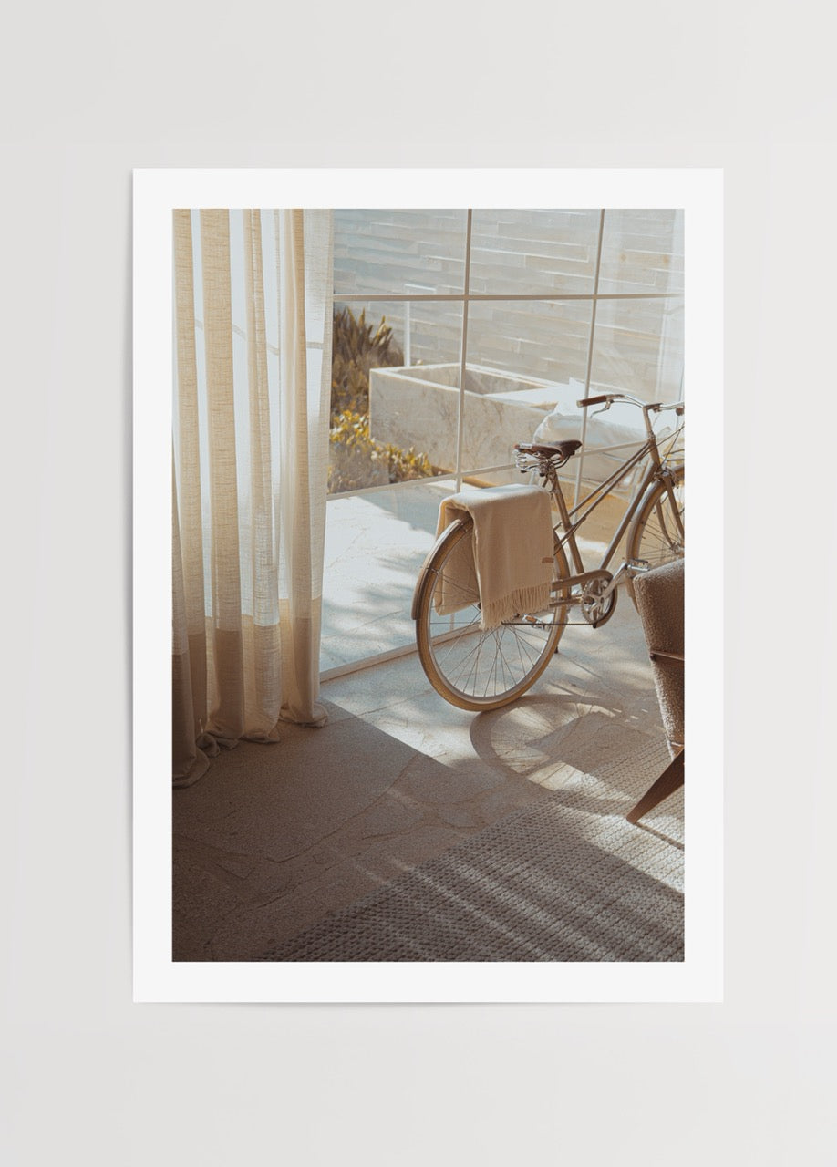 Poster of a bicycle illuminated by sunlight in a stylish interior.
