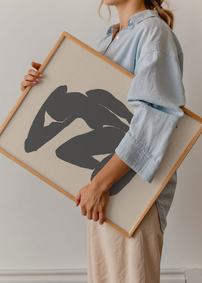 Abstract art print of a seated human figure in black on beige background.