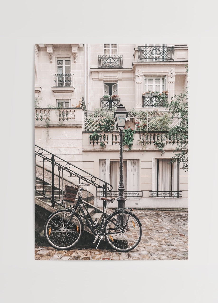 Vintage Parisian street scene with a bicycle and elegant architecture.