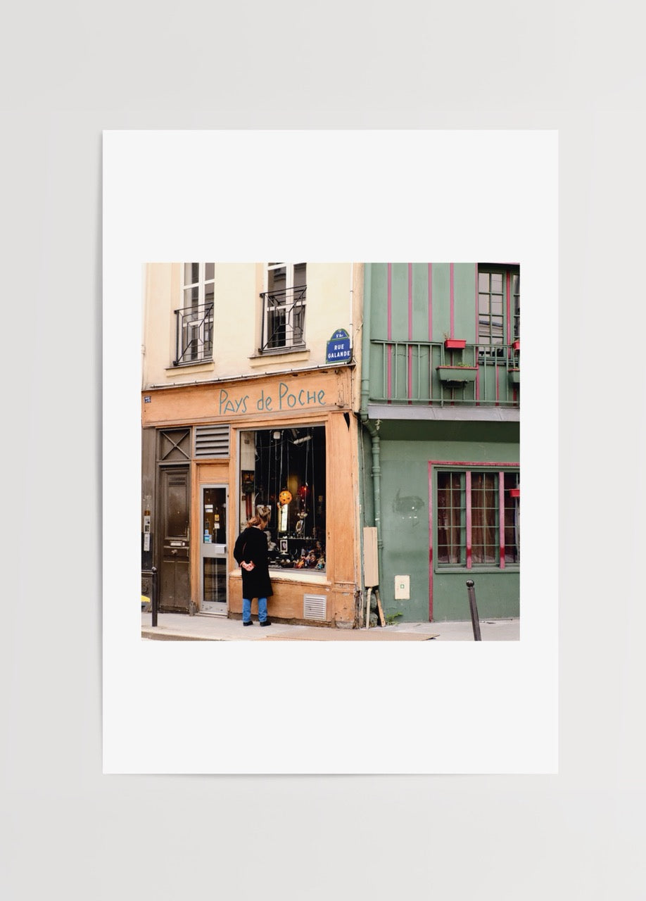 Photographic print of a quaint Paris storefront featuring soft hues.