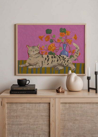 A playful cat lies among bright flowers on a pink background in this charming poster print.