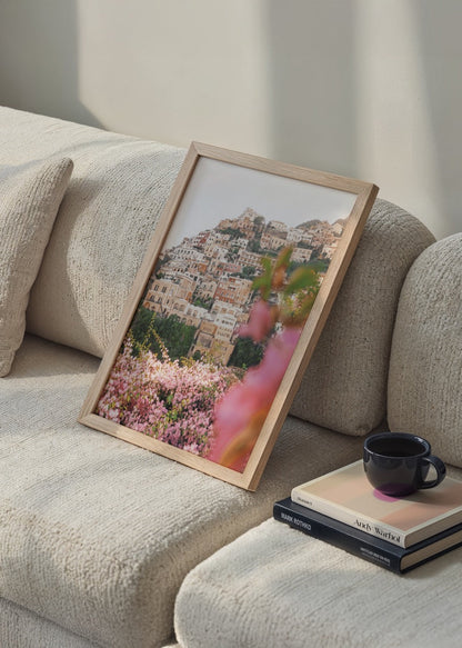 Stunning Positano floral scene with vibrant pink blossoms and coastal architecture.