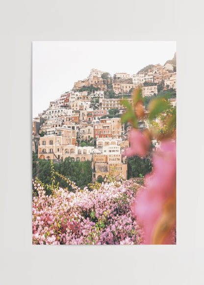 Stunning Positano floral scene with vibrant pink blossoms and coastal architecture.
