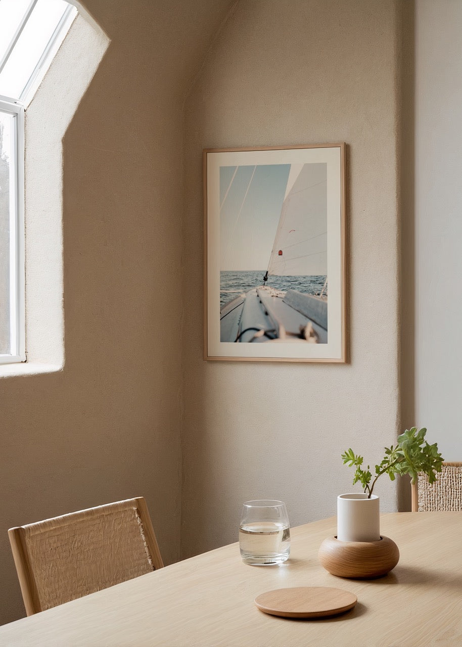 Minimalist art print of a sailboat on calm ocean waters.