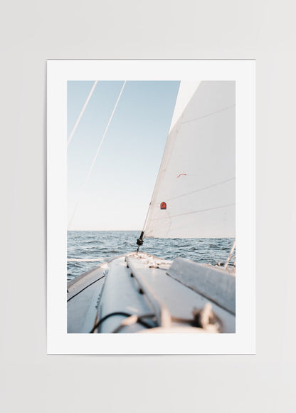 Minimalist art print of a sailboat on calm ocean waters.