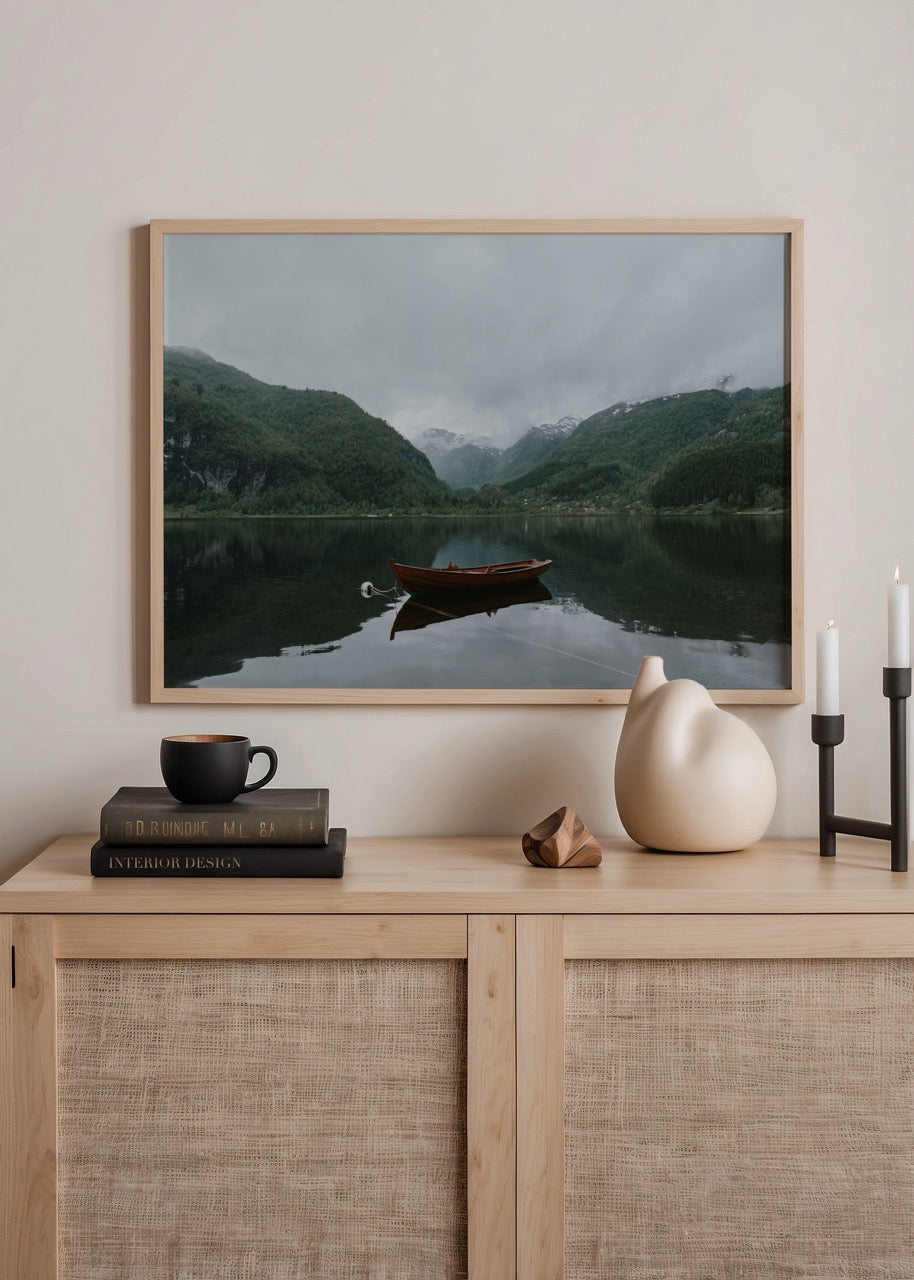 Art print of a tranquil lake with a solitary boat amidst mountains, perfect for wall decor.