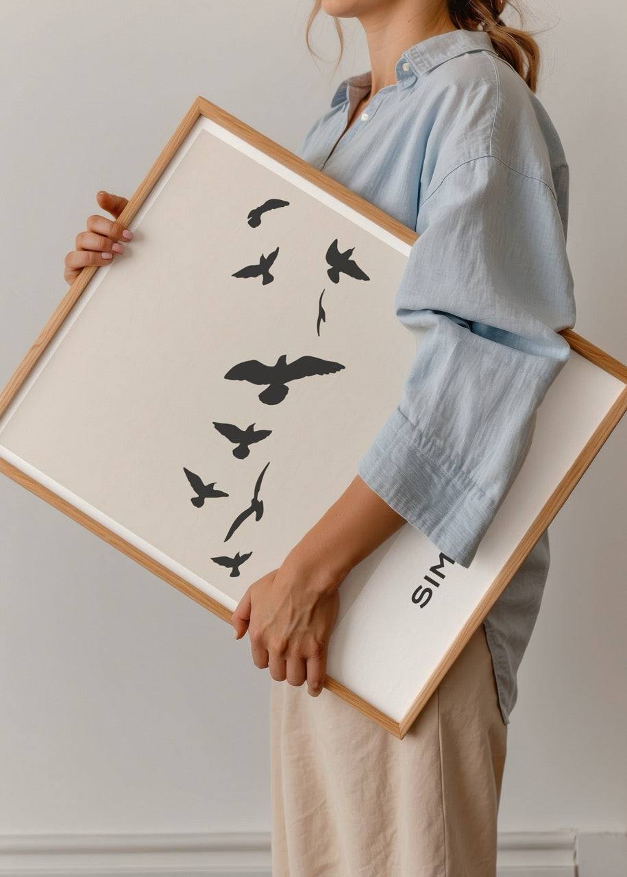 Silhouette of birds flying against a beige background