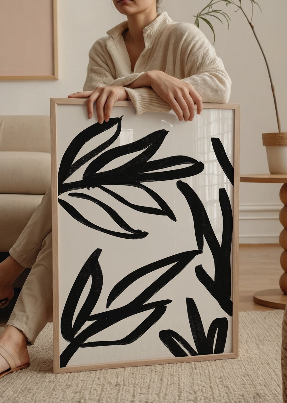 Dynamic leaf motif in bold black brushstrokes on white background.