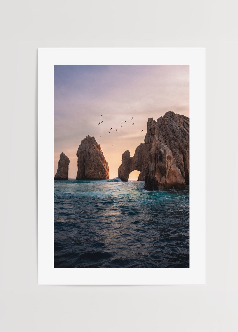 Serene sunset over an ocean arch capturing tranquil views.