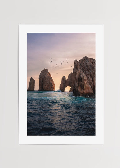 Serene sunset over an ocean arch capturing tranquil views.