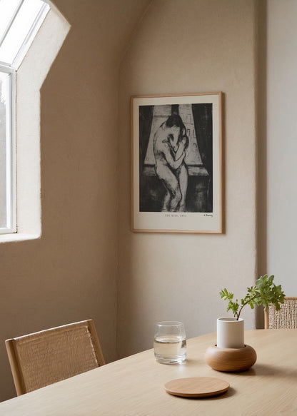 A black and white art print depicting a couple in an intimate embrace.