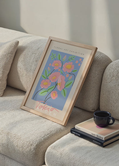 A vibrant floral poster featuring pink blossoms against a blue background, ideal for interior decor.