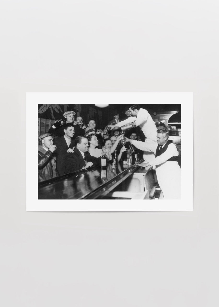 Vintage black and white print of a bustling bar scene.