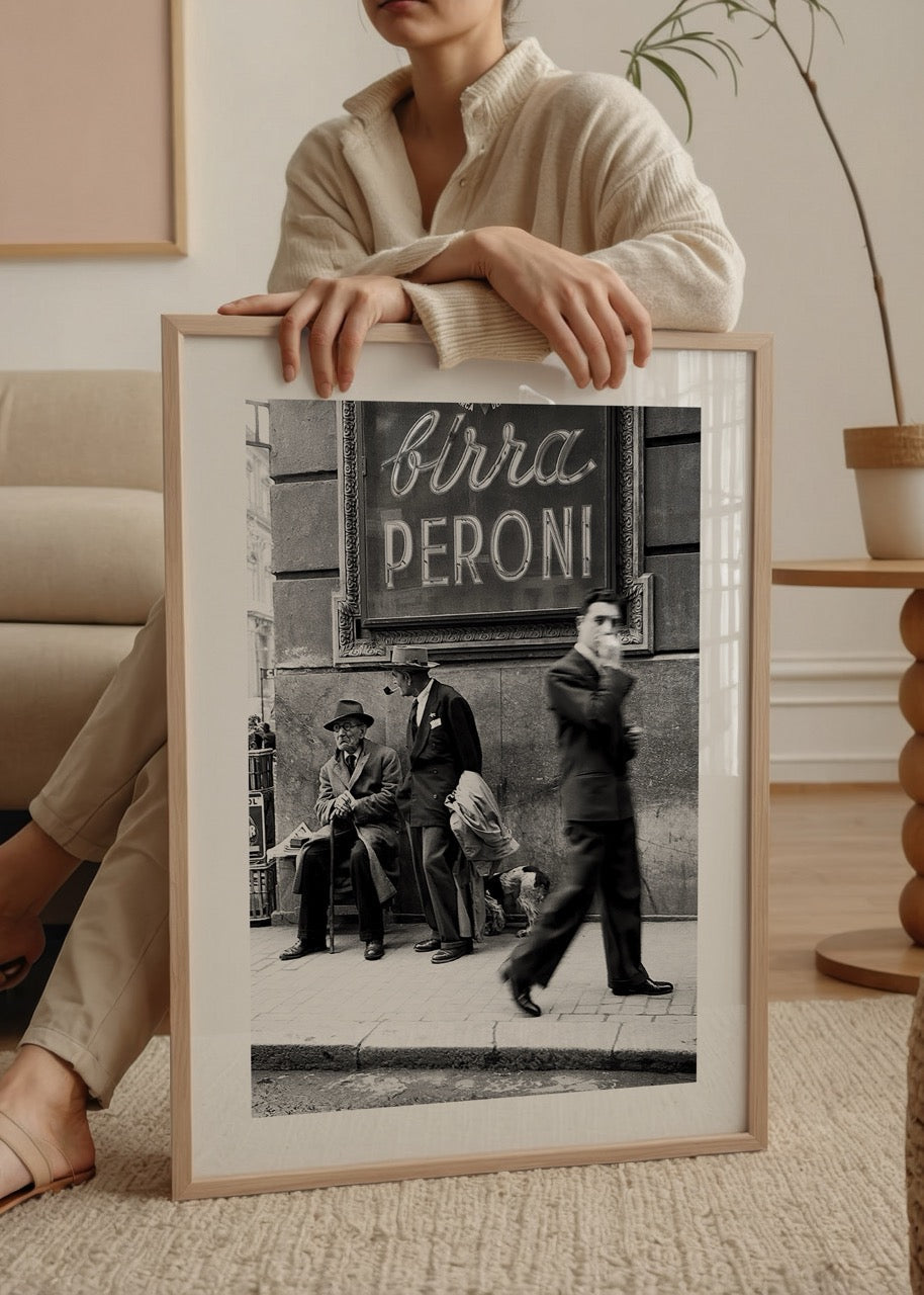 Black and white street scene poster art featuring figures and vintage signage.