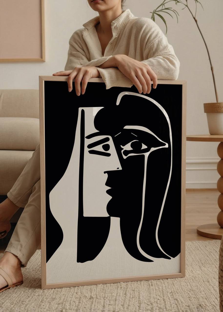 Monochrome artwork featuring abstract faces in bold lines.