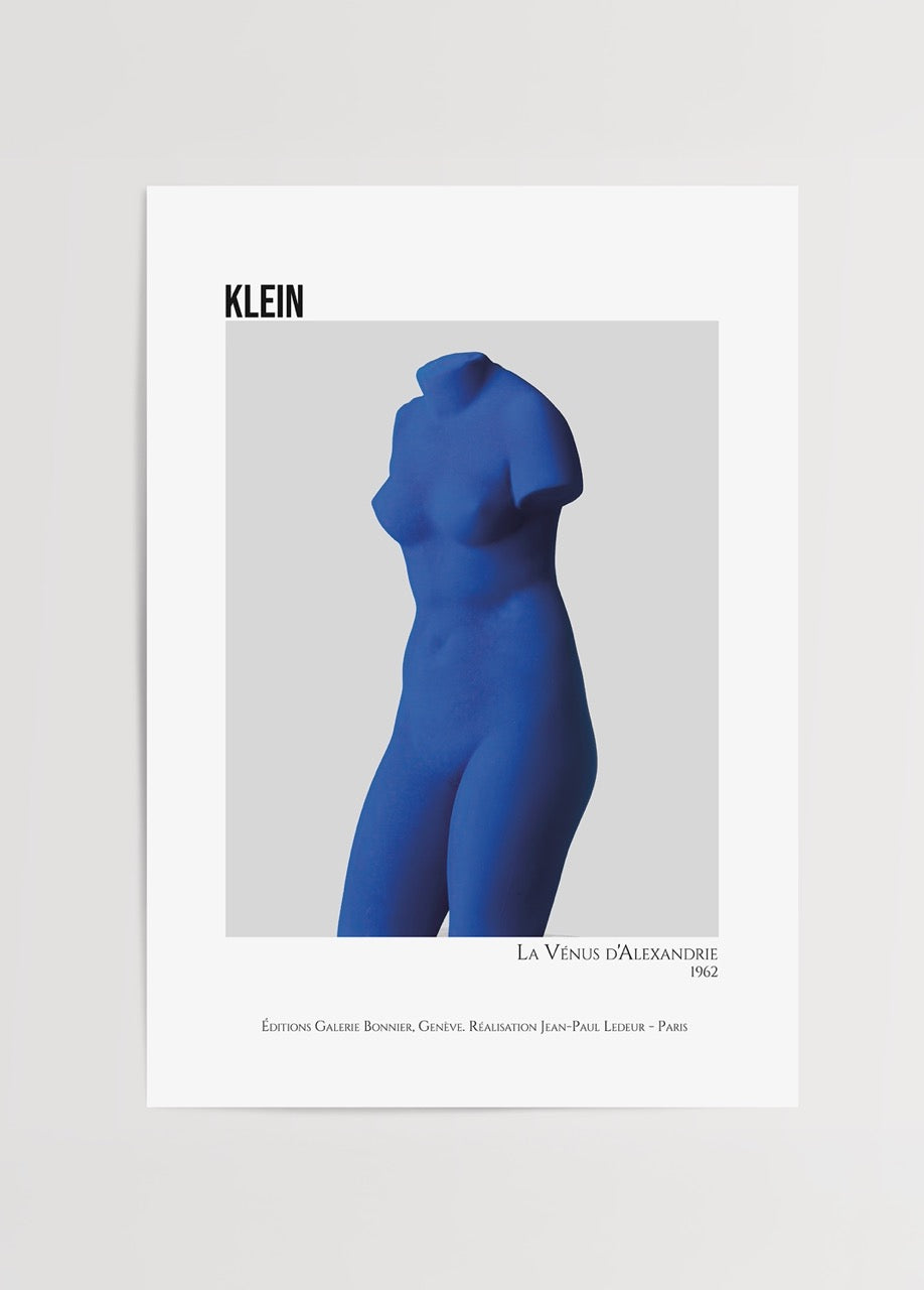 A bold blue sculptural figure featured in minimalist wall art.